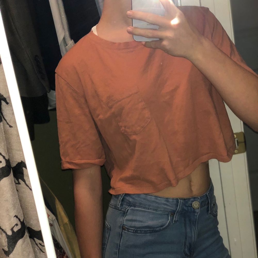 Orangey-peach colored loose fitting crop top